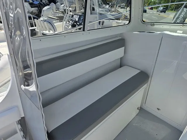 Slide: The Image of The 2027 Steiger Craft 21 Miami features a cushioned bench seat in a modern, light interior. - 5