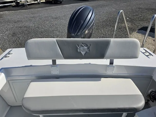 Slide: The Image of The image shows the stern of a Steiger Craft 21 Miami boat with a bench seat and outboard motor. - 8