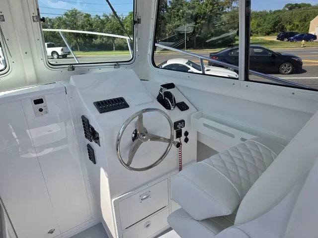 Slide: The Image of The 2027 Steiger Craft 21 Miami cockpit features a sleek white design with a modern steering wheel. - 4