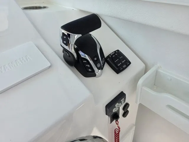 Slide: The Image of Close-up of a boat's helm console featuring a modern throttle lever and controls. - 7