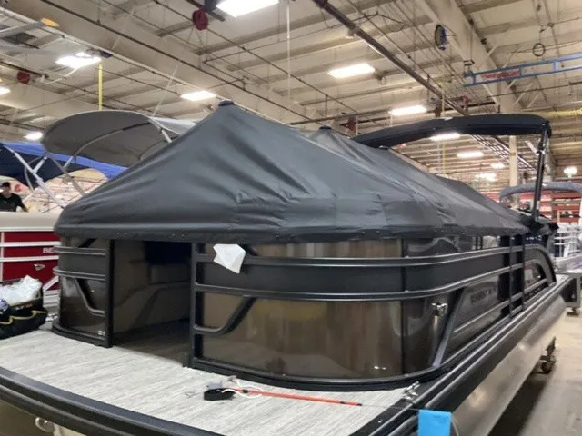 Slide: The Image of 2027 Bennington S Quad Bench 22 SSR Tritoon in a warehouse with a cover. - 18