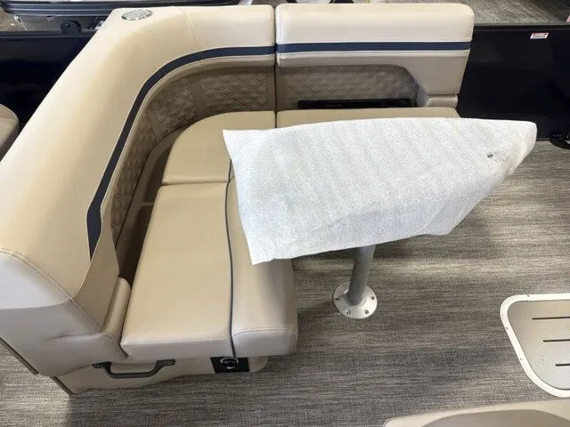 Slide: The Image of Interior of a Bennington S Fishing 22 SFC Tritoon with beige upholstered seating and table. - 14