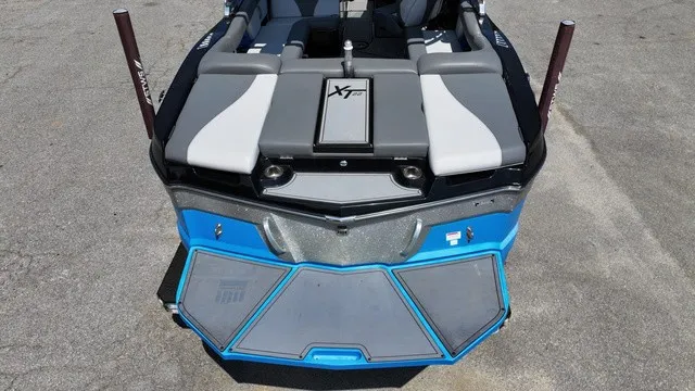 Slide: The Image of The image shows the rear of a 2019 MasterCraft XT22 boat with gray and blue accents. - 4