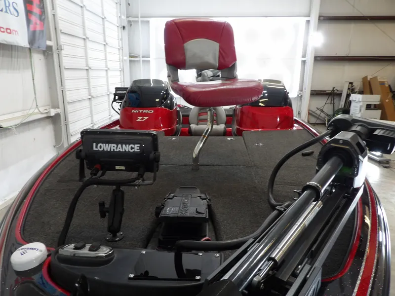 Slide: The Image of A 2010 Nitro Z-7 boat with a red seat and Lowrance electronics in a warehouse. - 15