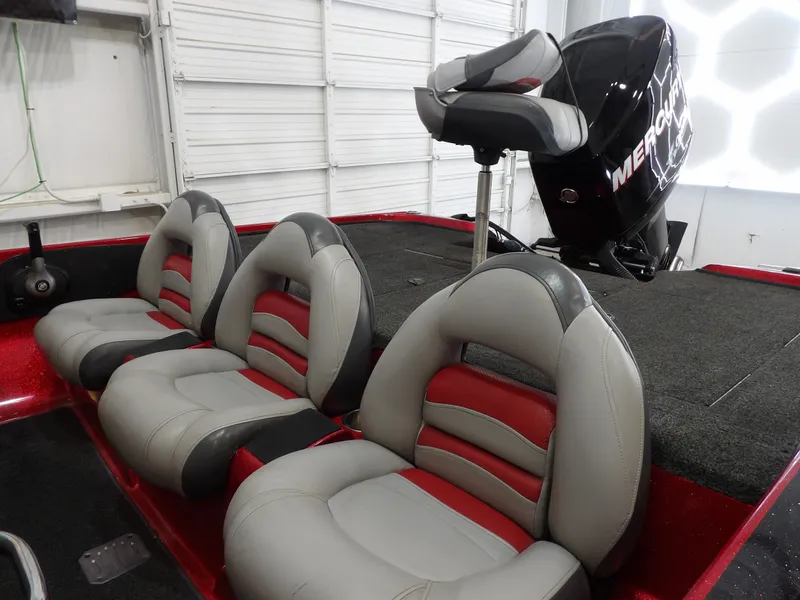 Slide: The Image of The image shows the interior of a 2010 Nitro Z-7 boat with gray and red seats. - 16