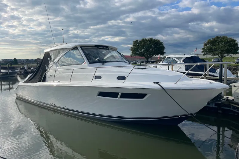 The Image of 2025 Pursuit OS 355 Offshore boat docked in a marina under cloudy skies. - 0