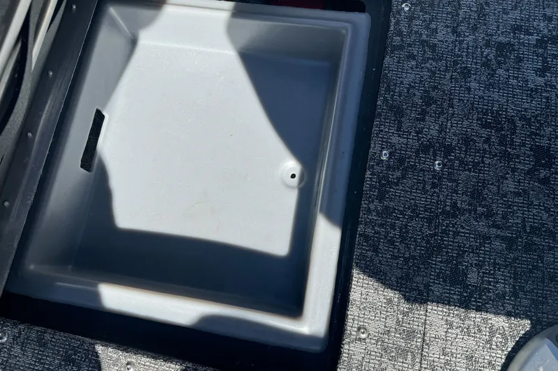 Slide: The Image of Storage compartment on 2025 Tracker Targa V-18 Combo boat, featuring textured flooring. - 18