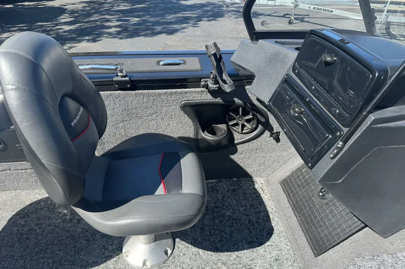 Slide: The Image of 2025 Tracker Targa V-18 Combo boat interior with black seat and dashboard. - 17