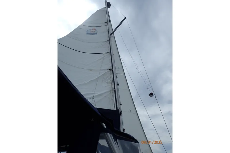 Slide: The Image of Sailboat mast and sail of 2011 Hake Seaward 32RK against cloudy sky. - 14