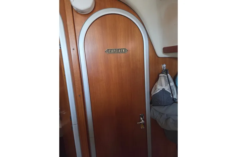 Slide: The Image of Wooden cabin door labeled "Captain" on a 2011 Hake Seaward 32RK boat. - 27