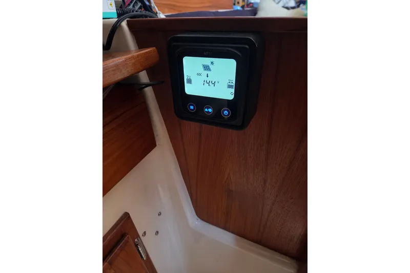 Slide: The Image of Control panel inside a 2011 Hake Seaward 32RK sailboat, displaying voltage reading. - 33