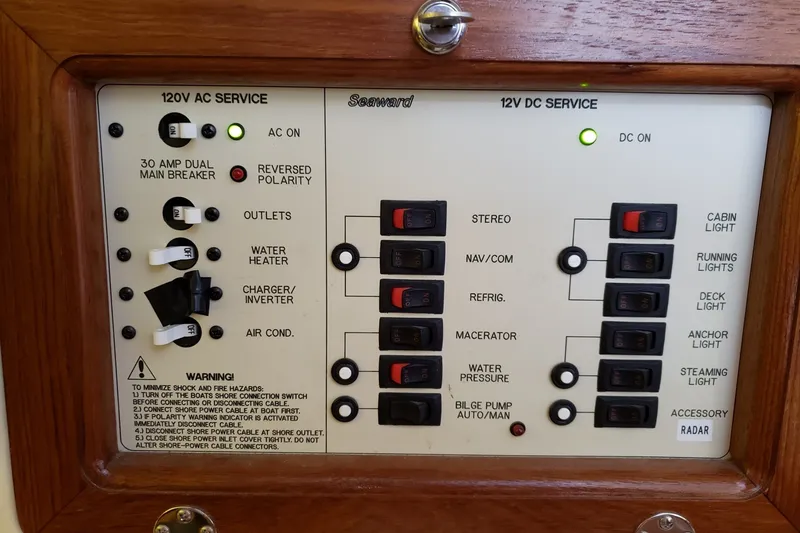 Slide: The Image of Electrical control panel of a 2011 Hake Seaward 32RK boat, featuring AC and DC services. - 37
