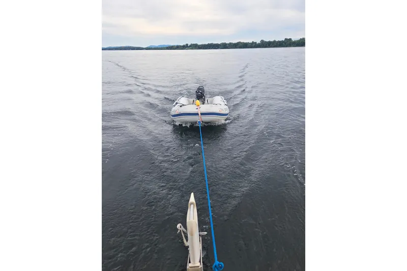 Slide: The Image of Towing a small inflatable boat on calm waters, viewed from a 2011 Hake Seaward 32RK. - 17