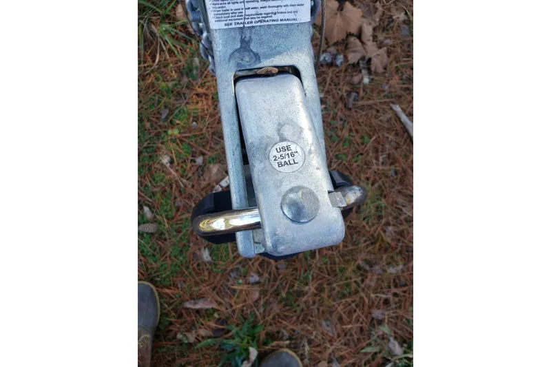 Slide: The Image of Trailer hitch coupler for 2011 Hake Seaward 32RK, labeled "Use 2-5/16 Ball," on grassy ground. - 56