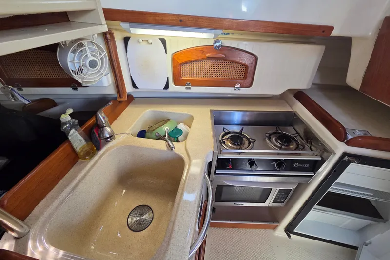 Slide: The Image of Compact galley kitchen in 2011 Hake Seaward 32RK sailboat with stove, sink, and storage. - 22