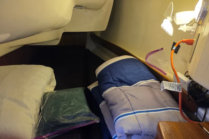 Slide: The Image of Cozy cabin interior of 2011 Hake Seaward 32RK sailboat with bedding and reading light. - 32