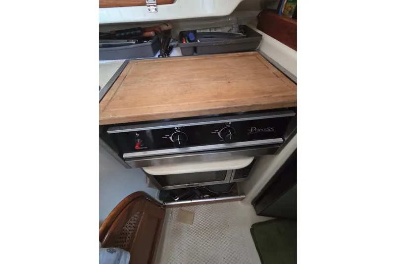 Slide: The Image of Compact kitchen area in a 2011 Hake Seaward 32RK sailboat with stove and cutting board. - 25