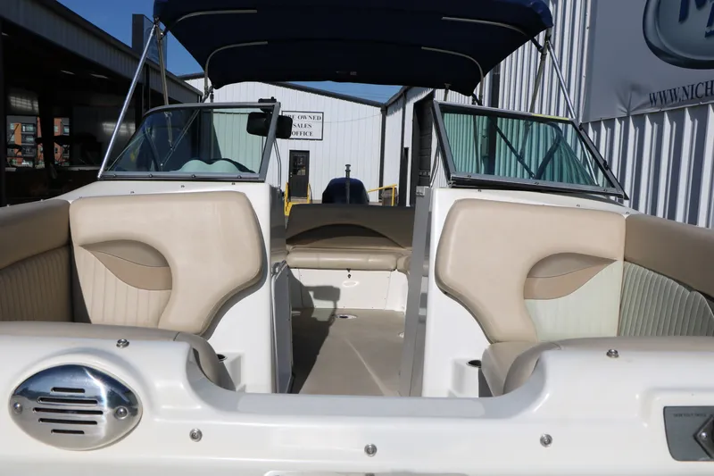 Slide: The Image of 2013 NauticStar 223DC Sport Deck boat interior with beige seating and canopy. - 17