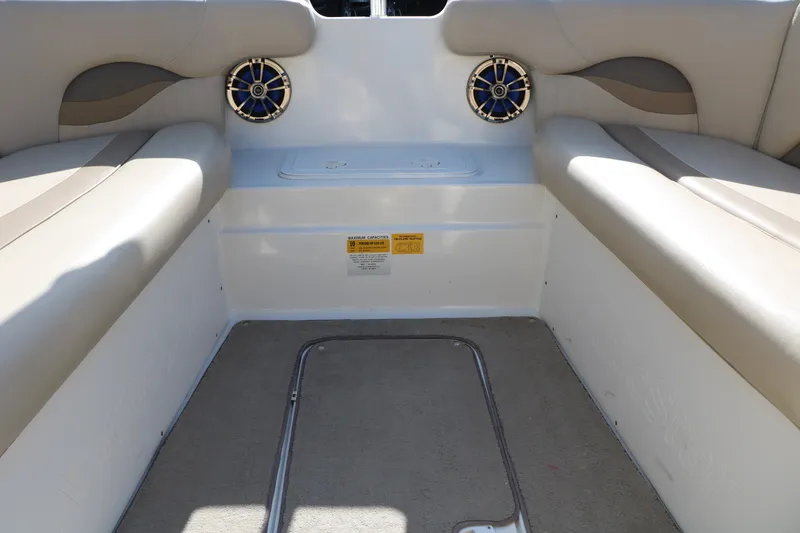 Slide: The Image of Interior of 2013 NauticStar 223DC Sport Deck boat with beige seating and speakers. - 31