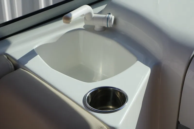 Slide: The Image of 2013 NauticStar 223DC Sport Deck boat sink and cup holder detail. - 38
