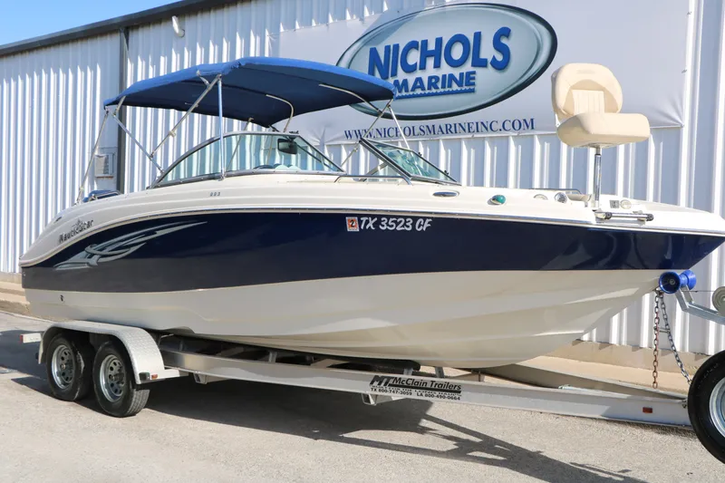 The Image of 2013 NauticStar 223DC Sport Deck boat on trailer at Nichols Marine. - 1