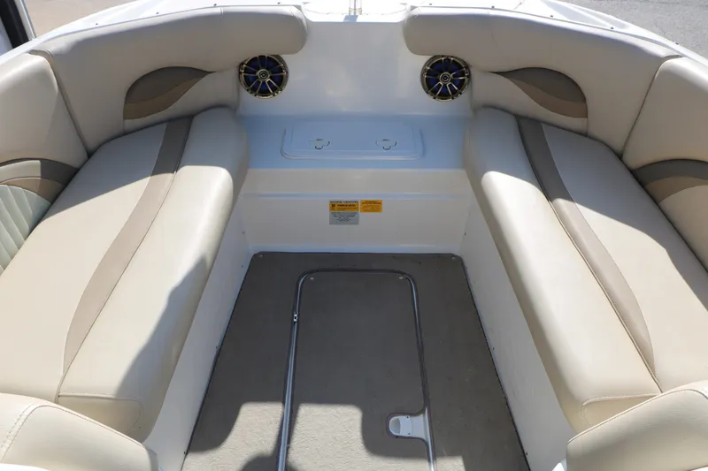 Slide: The Image of Interior of 2013 NauticStar 223DC Sport Deck boat with beige seating and speakers. - 23