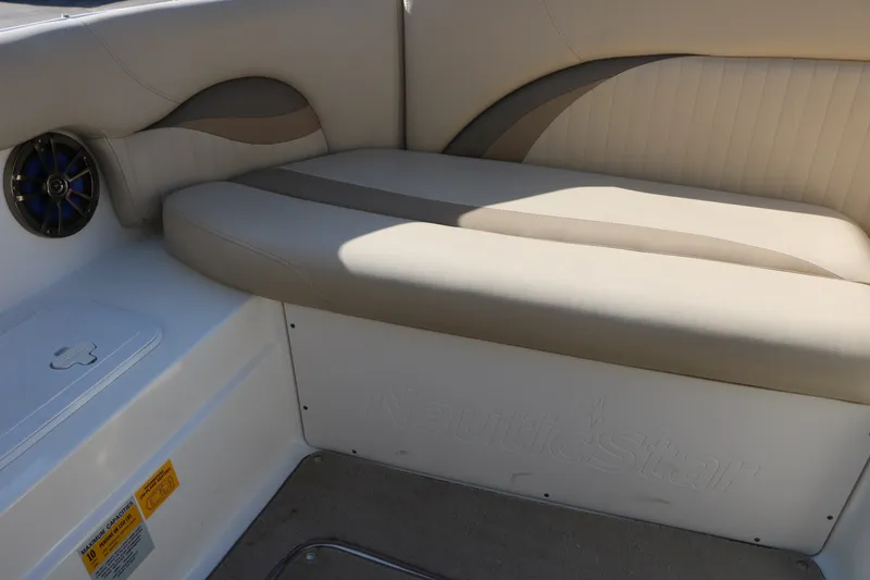 Slide: The Image of 2013 NauticStar 223DC Sport Deck boat interior with beige seating and speaker. - 33
