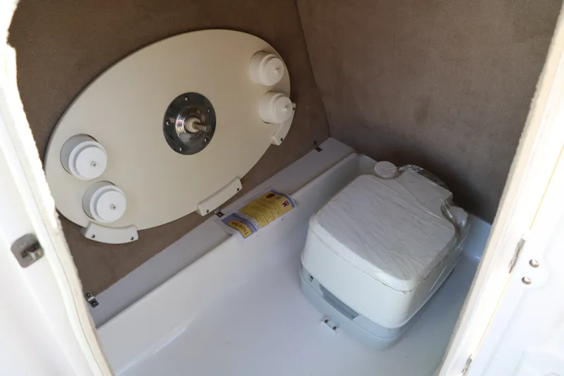 Slide: The Image of Interior of 2013 NauticStar 223DC Sport Deck boat with portable toilet. - 39