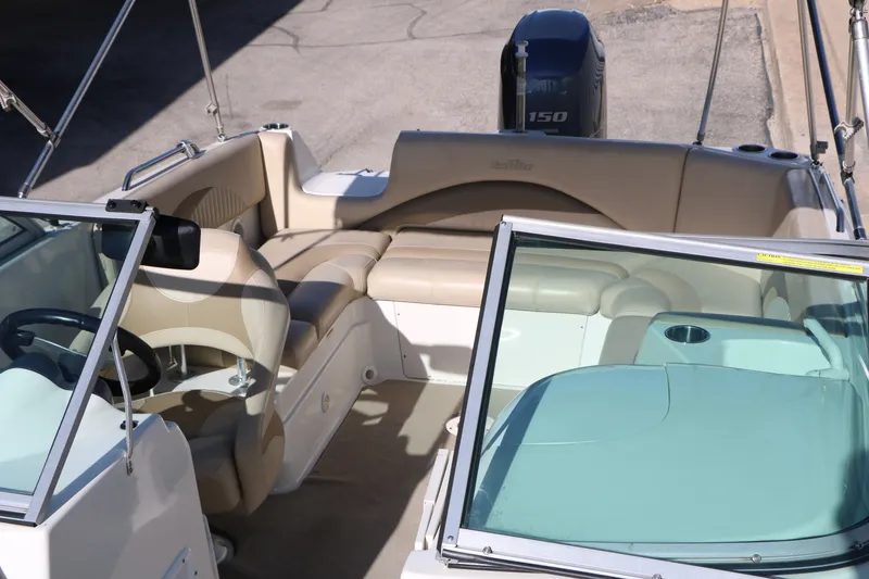 Slide: The Image of 2013 NauticStar 223DC Sport Deck boat interior with seating and steering wheel. - 26