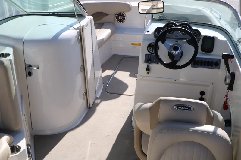 Slide: The Image of Interior of 2013 NauticStar 223DC Sport Deck boat with steering wheel and seating. - 20