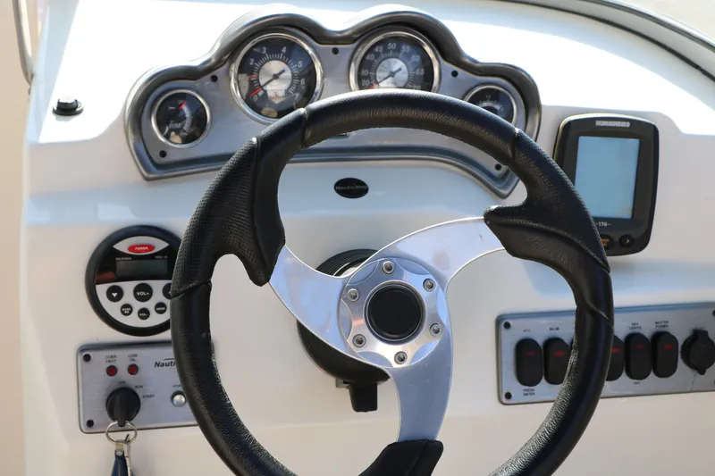 Slide: The Image of Steering wheel and dashboard of 2013 NauticStar 223DC Sport Deck boat. - 45