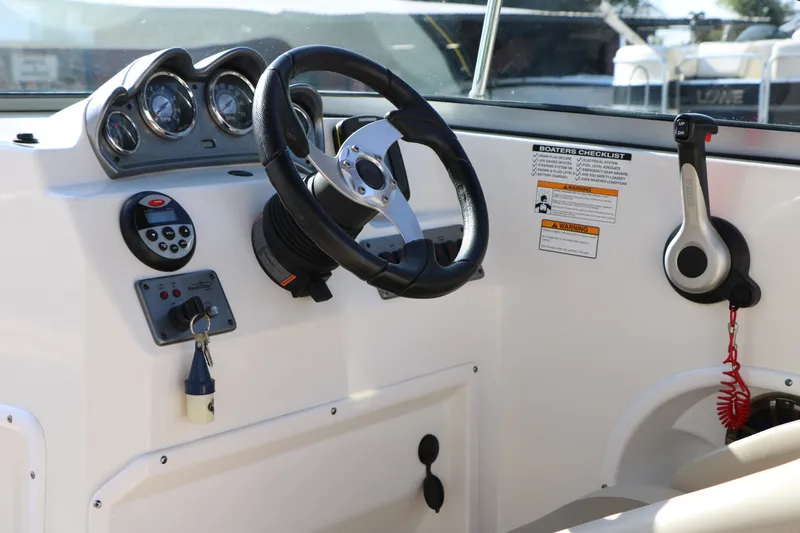 Slide: The Image of 2013 NauticStar 223DC Sport Deck dashboard with steering wheel and control panel. - 36