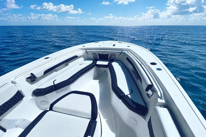 Slide: The Image of 2021 Tidewater 256 CC Adventure boat on open sea under blue sky. - 2