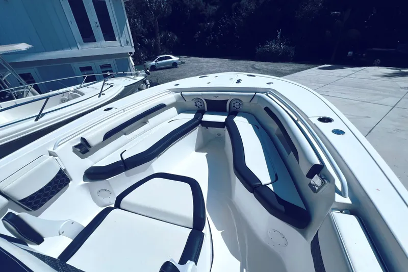 Slide: The Image of 2021 Tidewater 256 CC Adventure boat interior with sleek seating and modern design. - 16