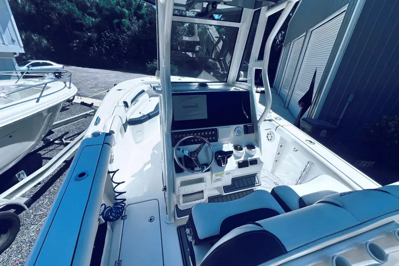 Slide: The Image of 2021 Tidewater 256 CC Adventure boat interior with modern helm and seating. - 11