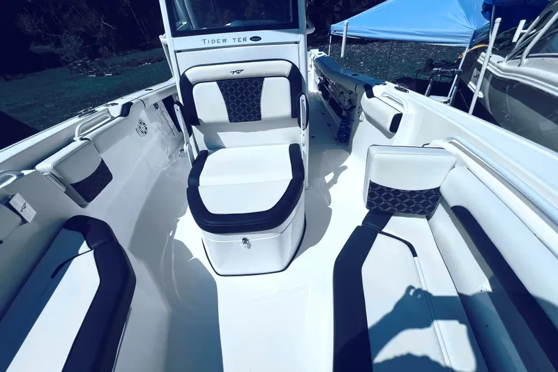 Slide: The Image of 2021 Tidewater 256 CC Adventure boat interior with cushioned seating and sleek design. - 20
