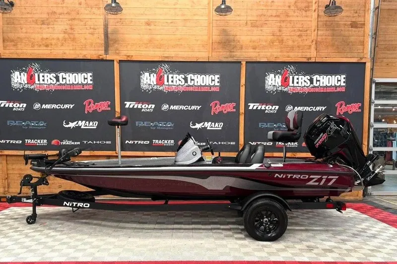 The Image of 2027 Nitro Z17 fishing boat showcased at Angler's Choice event with branded backdrop. - 1