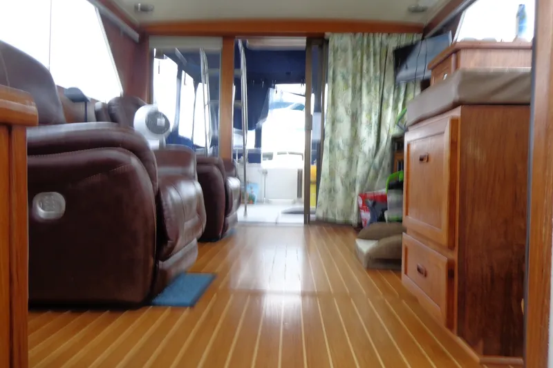 Slide: The Image of Interior of a 1975 Uniflite Flybridge Sport Sedan with wood flooring and leather seating. - 16