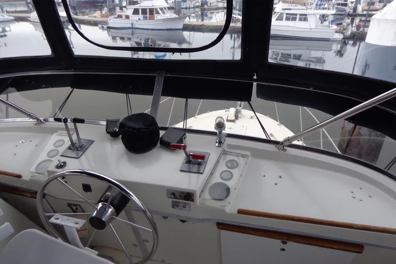 Slide: The Image of 1975 Uniflite Flybridge Sport Sedan helm with marina view in background. - 19
