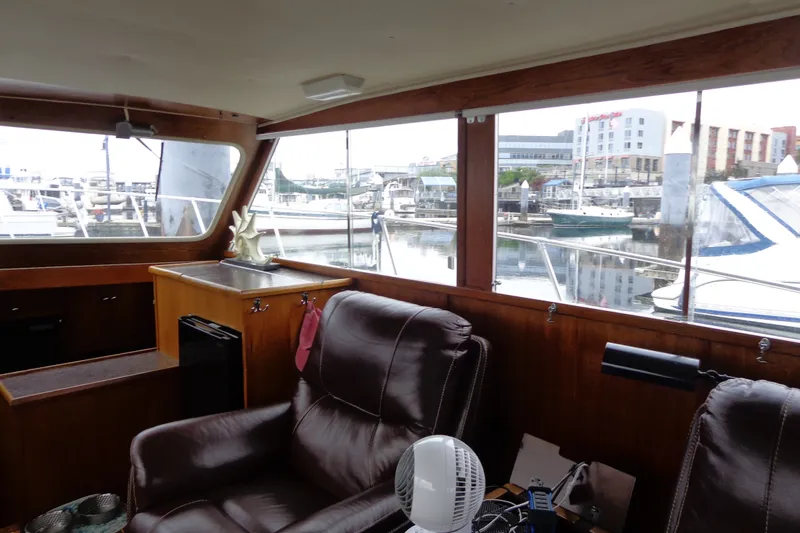 Slide: The Image of Interior of 1975 Uniflite Flybridge Sport Sedan with marina view through large windows. - 8