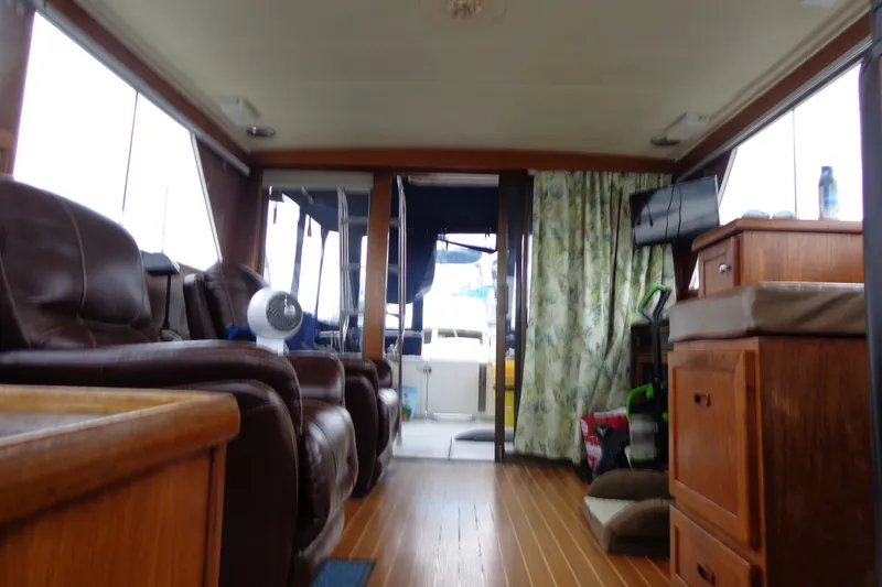 Slide: The Image of Interior of a 1975 Uniflite Flybridge Sport Sedan with leather seating and wooden cabinetry. - 17