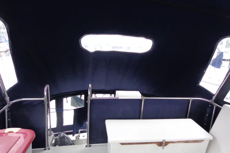Slide: The Image of 1975 Uniflite Flybridge Sport Sedan interior with dark canopy and railing. - 21