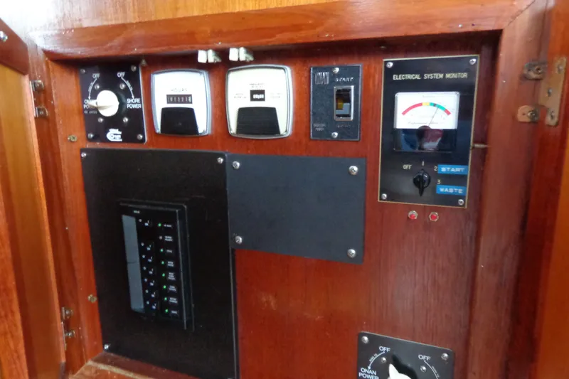 Slide: The Image of 1975 Uniflite Flybridge Sport Sedan electrical panel with gauges and switches. - 18