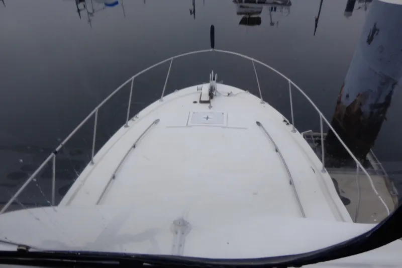Slide: The Image of 1975 Uniflite Flybridge Sport Sedan boat docked in calm waters. - 20
