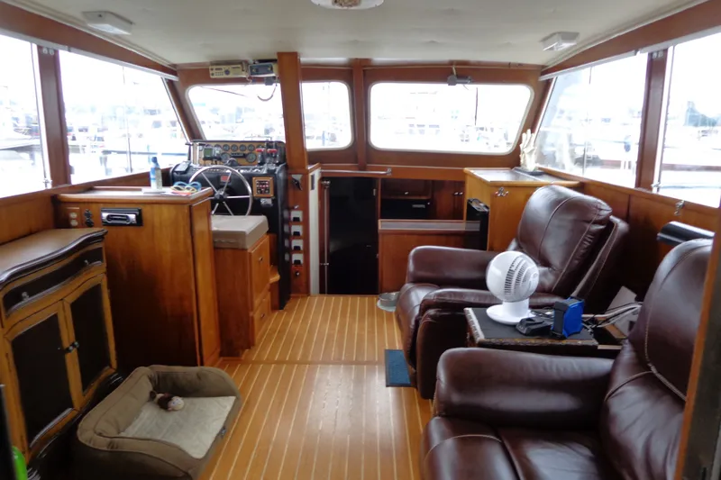 Slide: The Image of Interior of a 1975 Uniflite Flybridge Sport Sedan with leather seating and wooden accents. - 6