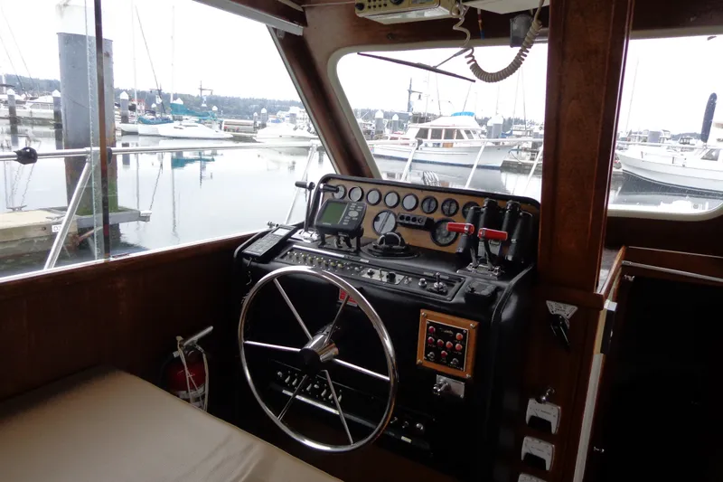 Slide: The Image of Interior view of a 1975 Uniflite Flybridge Sport Sedan boat at a marina. - 9