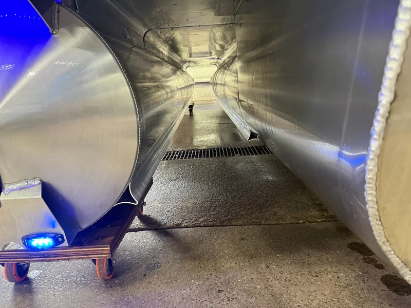Slide: The Image of Underside of a Bentley Pontoons Elite 223 Swingback Tritoon with three aluminum hulls. - 49