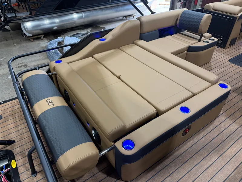 Slide: The Image of The image shows the luxurious interior of a Bentley Pontoons Elite 223 Swingback Tritoon with beige upholstery. - 23
