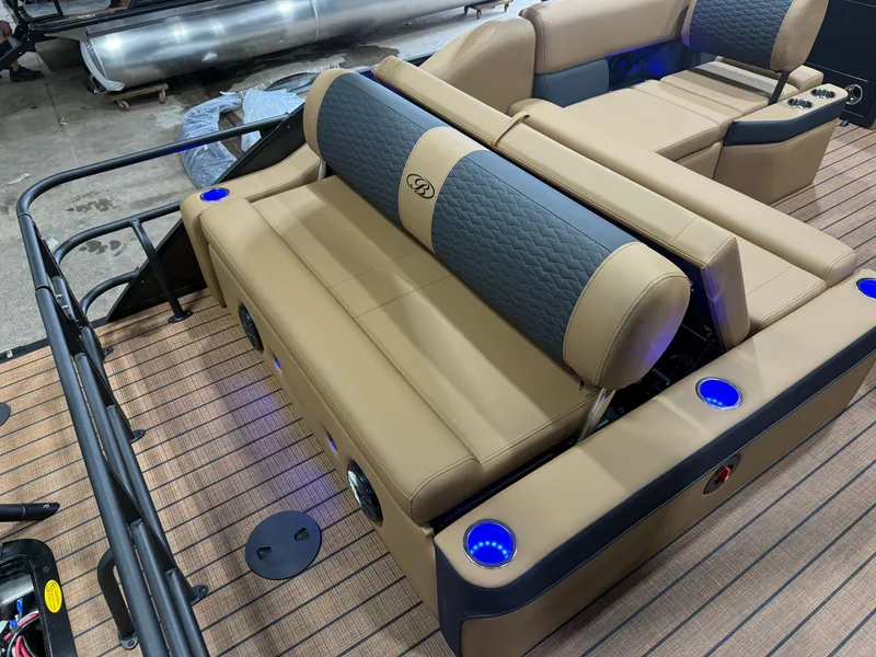 Slide: The Image of The image shows the luxurious interior of a Bentley Pontoons Elite 223 Swingback Tritoon with elegant seating and blue lighting. - 20