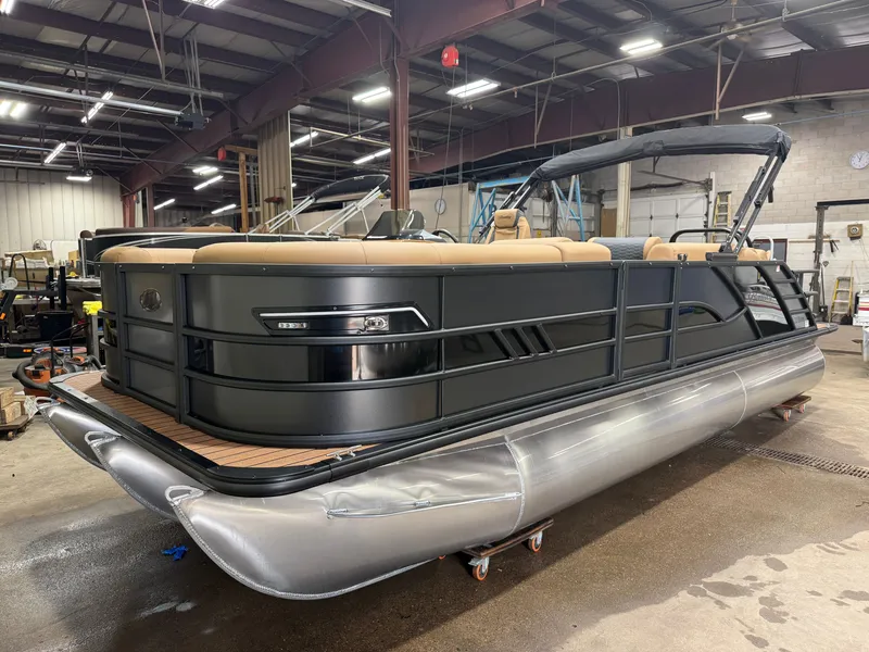 Slide: The Image of A 2027 Bentley Pontoons Elite 223 Swingback Tritoon is in a warehouse. - 43